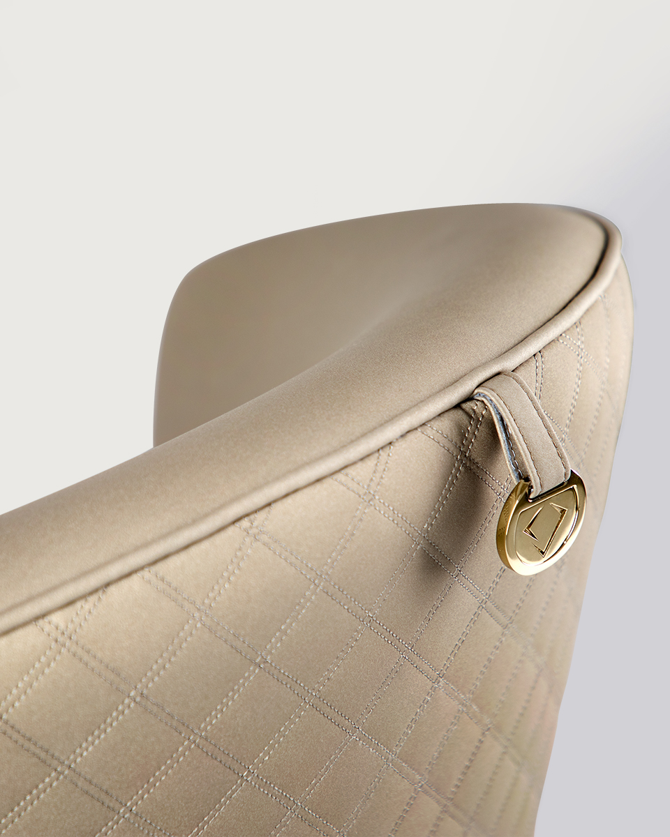 sedere armchair design, luxury upholstery, gold-plated brass legs