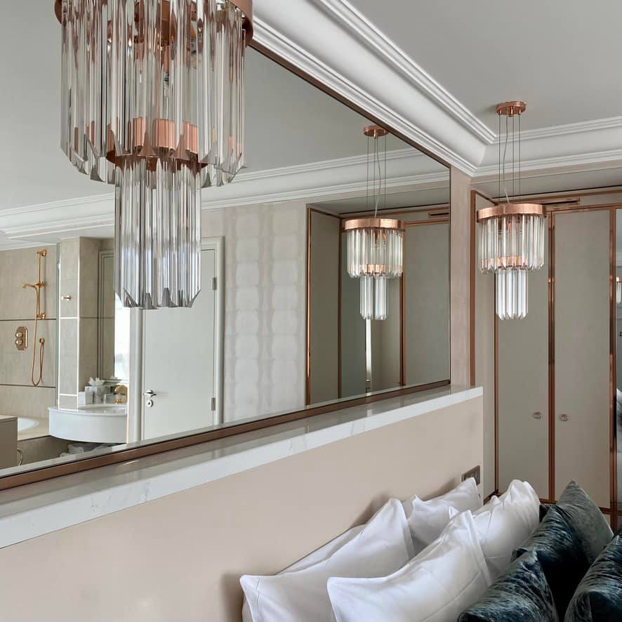 Paris hotel suite with Royal Pendant by Castro Lighting, blending pink elegance with regal charm.